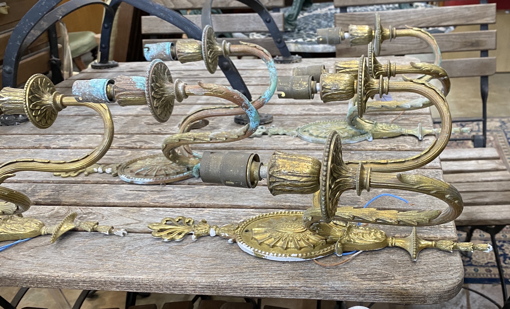 A set of four Sheraton style gilt metal two branch wall lights, height 36cm